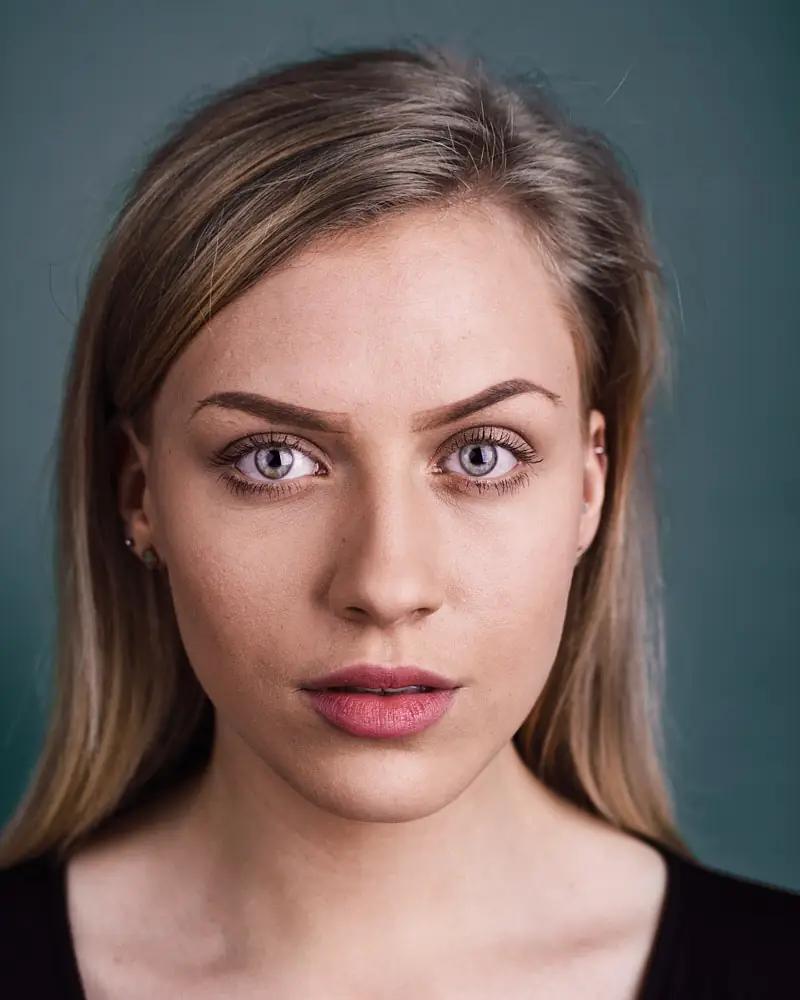 Actor headshot with a neutral studio backdrop
